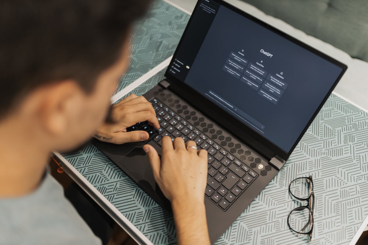 Professional using AI tools on a laptop for business work
